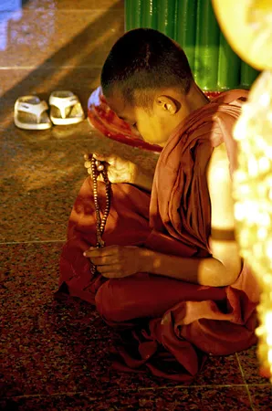 Young monk praying at Sule Pagoda