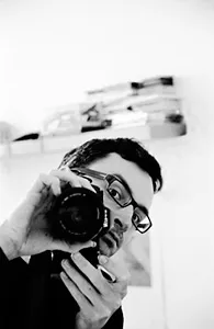 Patrick Peron, a self-portrait holding a camera